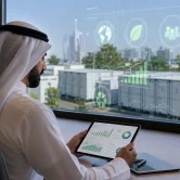Business professional reviewing ESG and sustainability data with battery storage facility in background